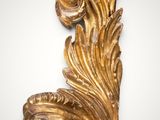 an ornate gold leaf decoration on a white background