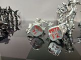 some metal figurines that are on display on a table