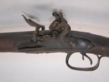 an old gun with a man sitting on top of it