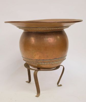 an image of a brass pot on a stand with a lid