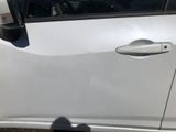 a white car that has a door handle on the side of it