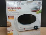 an electric single hotplate is in the box on the table