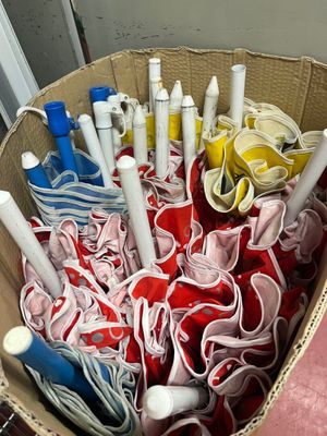 a basket full of pens and other items in it