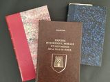 three books sitting on top of a black table next to each other