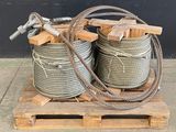 two large coils of rope sitting on top of a wooden pallet