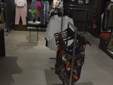 a display of clothes in a clothing store with a mannequin
