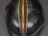 an old helmet with a gold stripe on the side of it