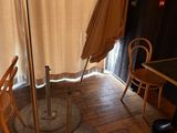 a table and chairs in a room with an umbrella