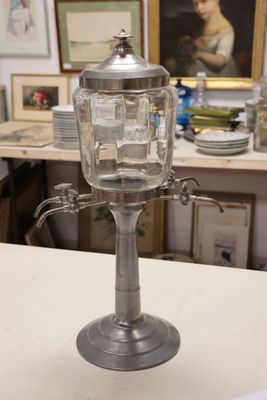 a glass jar with ice inside of it sitting on a counter