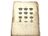 an old book with a bunch of crowns on top of it