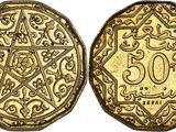 a gold coin with an ornate design on the front and back