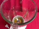 a blender with a glass bowl on a red cloth