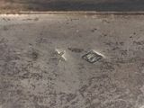 an old silver metal box with a metal lid on a white surface