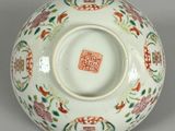 a white bowl with a red and green design on it