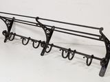 pair of wrought iron coat racks with hooks