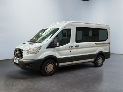 the white van is parked in the large room of the building
