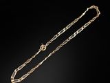 an image of a gold necklace on a black background