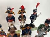 seven figurines of men dressed in military uniforms