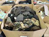 many boxes full of clothes that are sitting on the floor