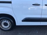 a small white van parked in a parking lot