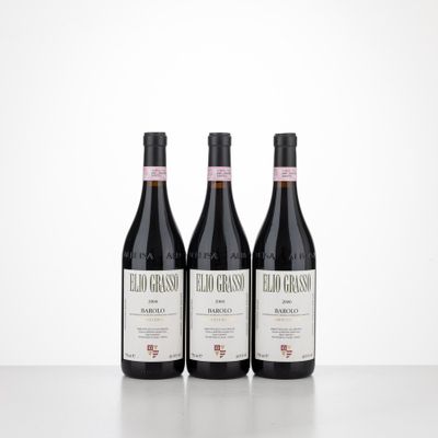 three bottles of red wine sitting on top of a table