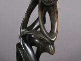 sculpture of a man sitting on a chair with his head in his hands