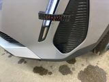 a close up of a car ' s grille with a sticker on it