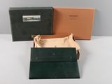 two boxes of green and brown leather on a white surface