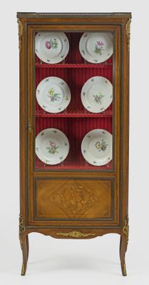 a cabinet with plates in it and a glass door