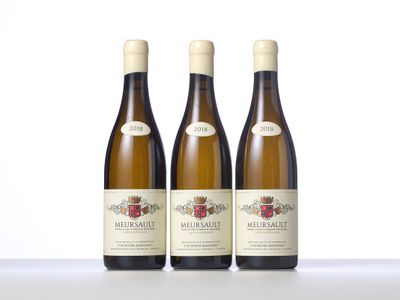 three bottles of wine sitting on top of a table