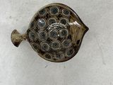 an image of a decorative glass fish on a white surface
