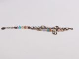 a close up of a bracelet on a white surface