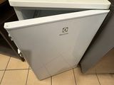 a coffee pot sitting on top of a small refrigerator