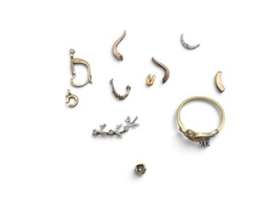 several different types of jewelry are arranged on a white surface