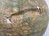 a globe with a hole in the middle of it