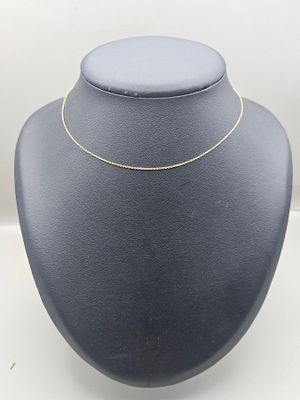a black mannequin with a gold chain on top of it