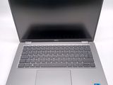 an open laptop computer sitting on top of a white table