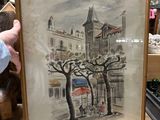 someone is holding up a picture of a building with a clock tower