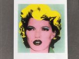 framed photograph of a woman with yellow hair and a black lip