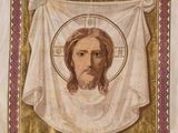 a close up of a painting of jesus on a gold cloth
