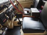 a steering wheel in the driver ' s seat of a bus