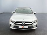a white mercedes cla parked in a white room