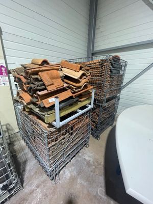 a pile of wood in a wire basket next to a toilet