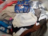 a pile of clothes in a basket on the floor