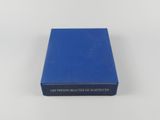 un livre bleu posé sur une table blanche