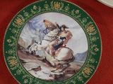 a plate with a picture of a man riding a horse