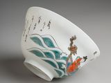 a white bowl with a painting on it sitting on a table