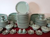 a lot of plates and bowls on the table