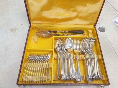 a yellow case with silverware in it on the floor