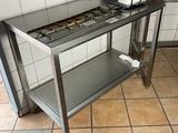 tiled floor in a restaurant kitchen with stainless steel table and appliances